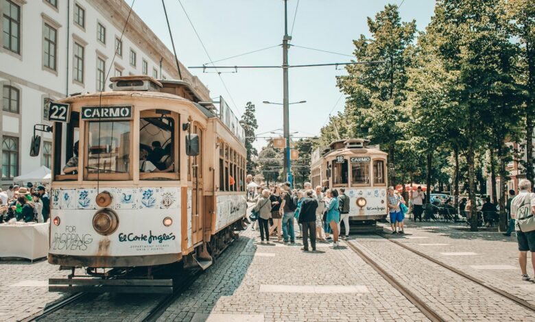 people walking on street near white and brown tram during daytime