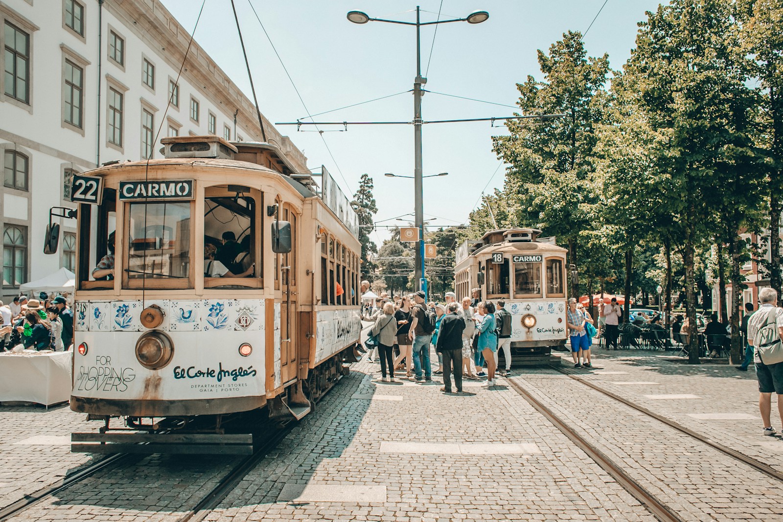 people walking on street near white and brown tram during daytime