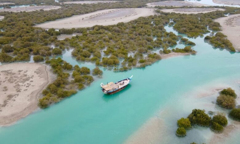 A large boat floating on top of a blue river
