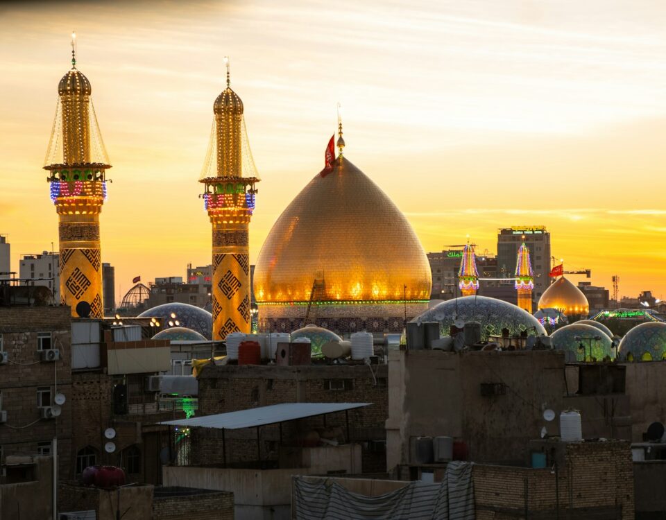 A sunset view of a city with tall buildings