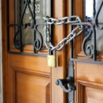 grey metal chain on brown wooden door