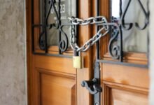 grey metal chain on brown wooden door