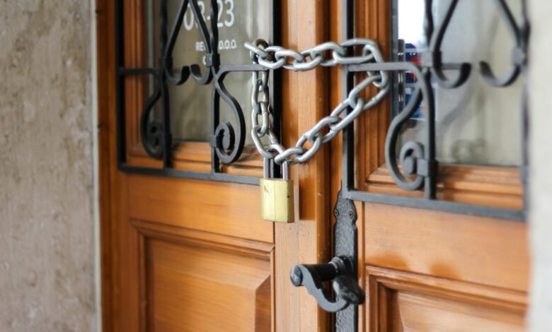 grey metal chain on brown wooden door