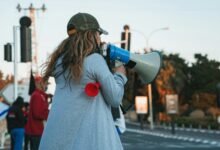 a woman drinking from a bottle